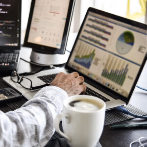 Person manipulating financial graphics on a laptop